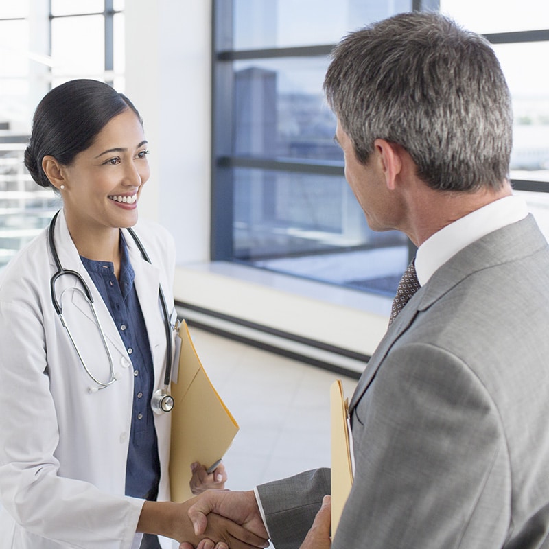Doctor and businessman shaking hands